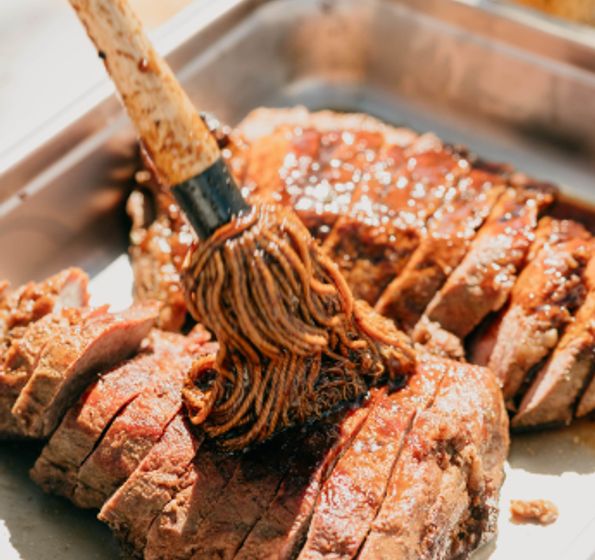 Chef basting Prime steak with herbs and butter