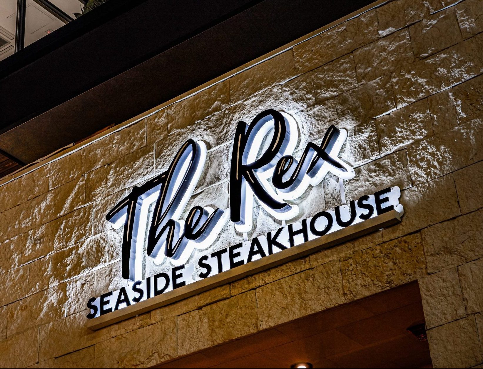 The Rex Seaside Steakhouse exterior illuminated sign