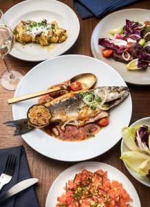 Whole branzino with cherry tomatoes and capers