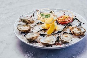 Fresh oysters on ice with lemon and mignonette